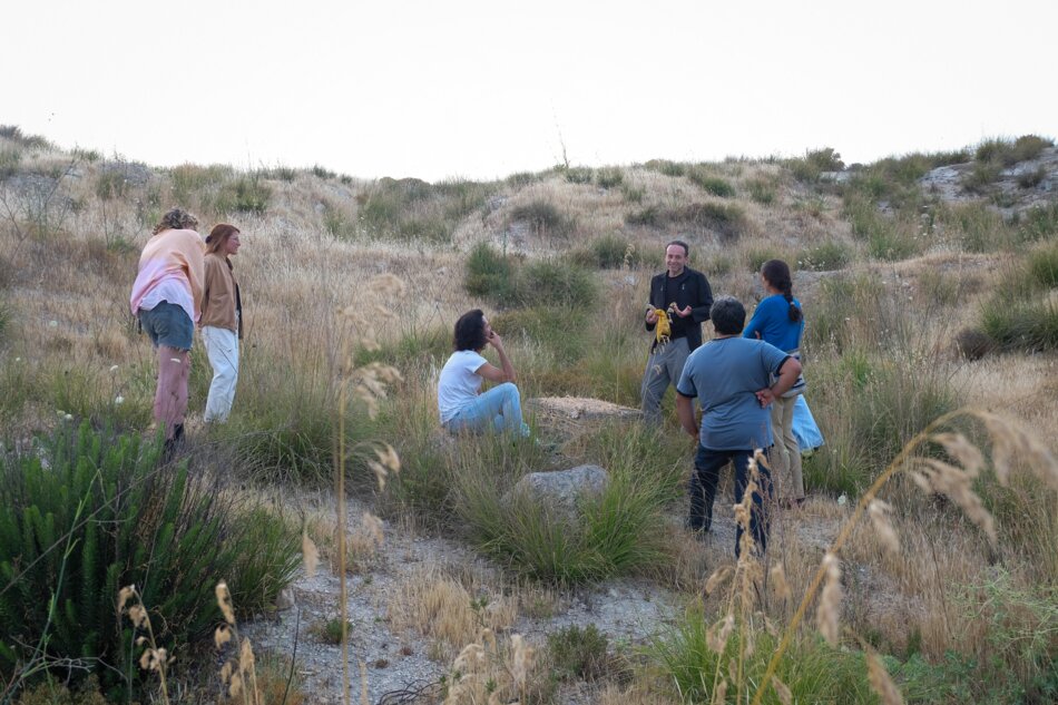 Six people in a rural area.